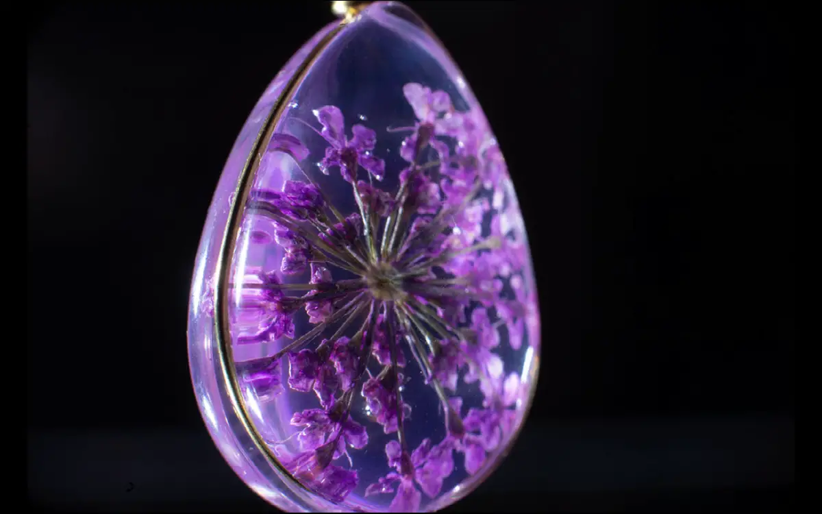 purple flower in resin pendant