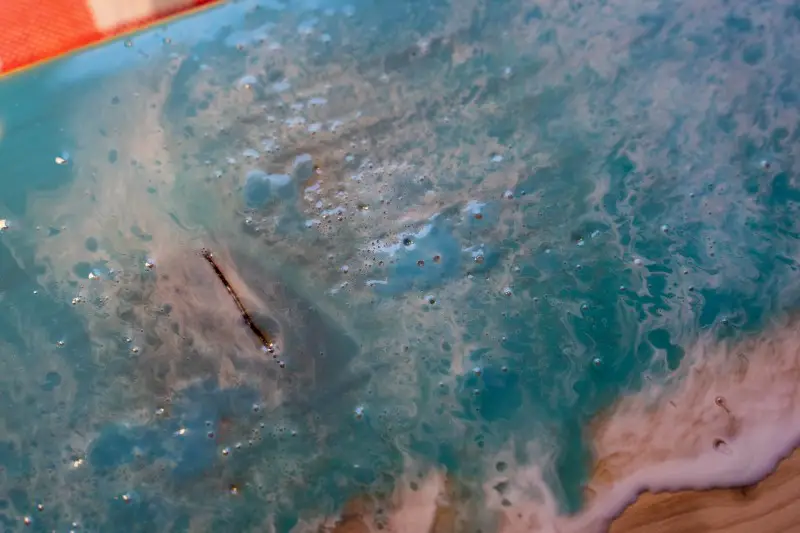 Bubbles in the surface of a piece of dried resin art
