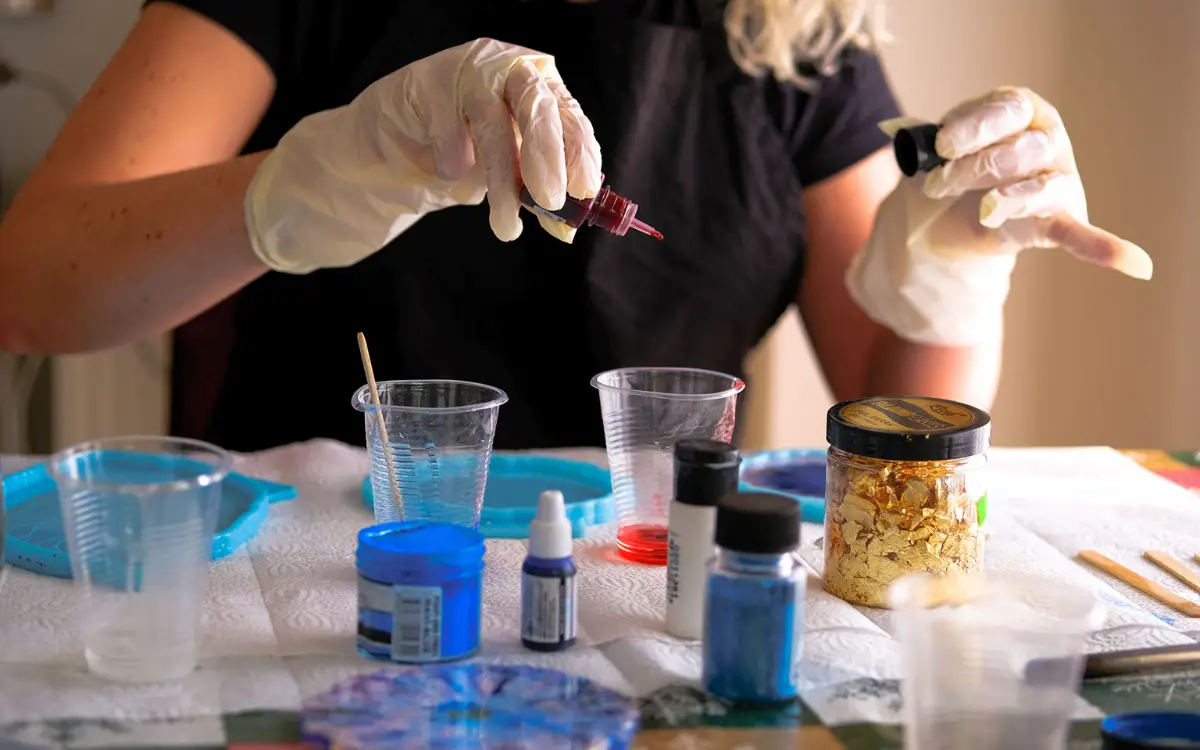 woman making resin art with resin art supplies